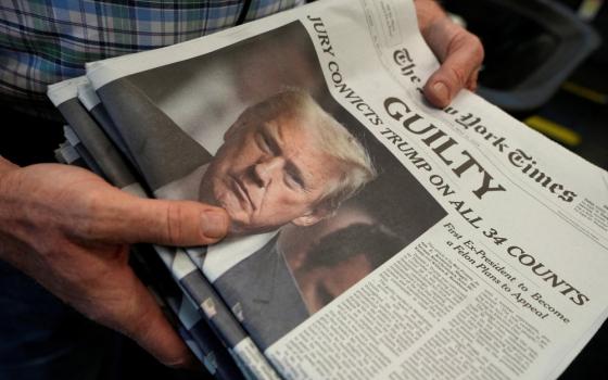 Stack of papers held in man's hands. 