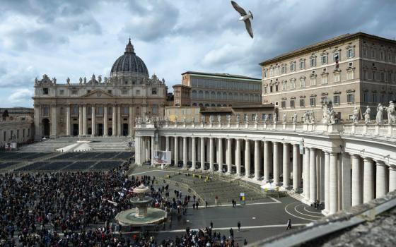 Wide view of St. Peter's Square, with large crowd gathered before the colonnade