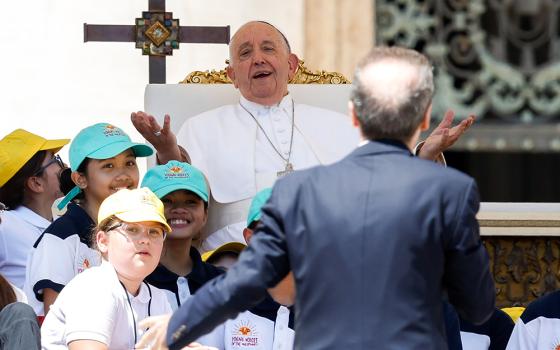 Pope Francis shares a laugh with Italian actor, Roberto Benigni, as Benigni gives the closing talk in St. Peter's Square at the Vatican May 26, 2024, wrapping up the first World Children's Day held May 25-26. (CNS/Lola Gomez)