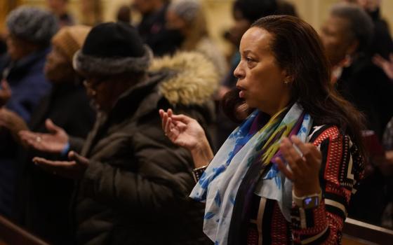 People raise their hands in prayer