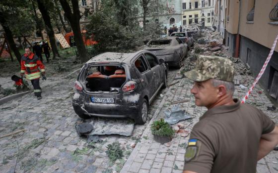 Emergency personnel examine the area around a residential building that was hit by a Russian missile strike in Lviv, Ukraine, July 6, 2023. The missile attack killed at least four people, injured 37 others and destroyed hundreds of buildings.