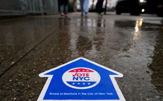 A sign directing people to vote in the New York Presidential Primary election is seen on the pavement in New York City April 2 (OSV News/Reuters/Adam Gray)