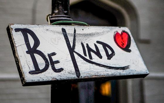 Painted sign that says, "Be Kind" (Unsplash/Adam Nemeroff)
