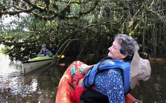 Adrian Dominicans Sr. Lorene Heck (foreground) and Sr. Mary Priniski with Achuar guide Celestino Antik, travel on the Pastaza River during an ecotourism trip through Maketai, a nonprofit co-founded by Adrian Dominican Sr. Judy Bisignano. The ecotrips give Western visitors a close-up introduction to both the Achuar and the Amazon. (Courtesy of Lorene Heck)