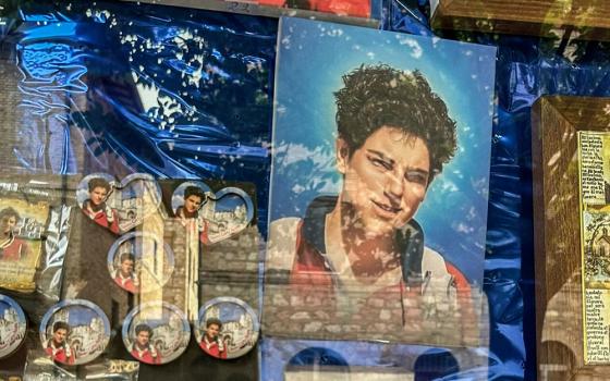 Carlo Acutis souvenirs are displayed in a shop window in Assisi, Italy, in June 2023. (RNS/Michael Di Giovine, CC BY)