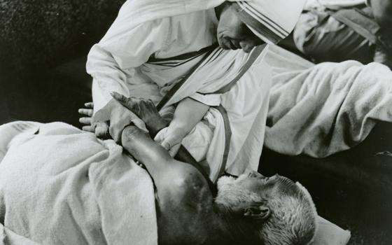 Mother Teresa of Kolkata cares for a sick man in an undated photo. (CNS/KNA)