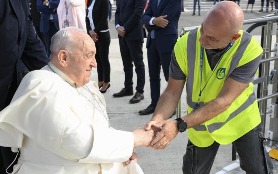 Pope Francis, seated in a wheelchair, greets an airport worker as he prepares to board an ITA flight at Rome’s Fiumicino airport Sept. 2, 2024, for an overnight flight to Jakarta, Indonesia. His 45th international trip and the longest of his papacy, will take him to Indonesia, Papua New Guinea, Timor-Leste and Singapore. (CNS photo/Vatican Media)