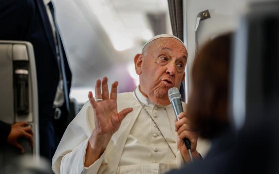 Pope Francis answers a question from a journalist aboard his flight back to Rome Sept. 13, 2024, after visiting Indonesia, Papua New Guinea, Timor-Leste and Singapore. (CNS/Lola Gomez)