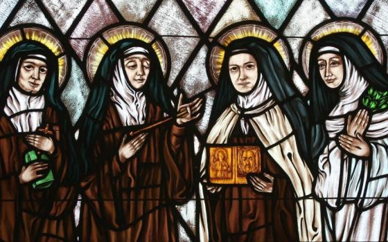 St. Therese of Lisieux is featured holding an image of the Holy Face in this stained glass depiction of female saints in the church of St. Therese, Montauk, N.Y. Illustrated are Sts. Teresa Benedicta of the Cross, Theresa of Avila, Thérèse of Lisieux and Catherine of Siena. (OSV News photo/Gregory A. Shemitz)