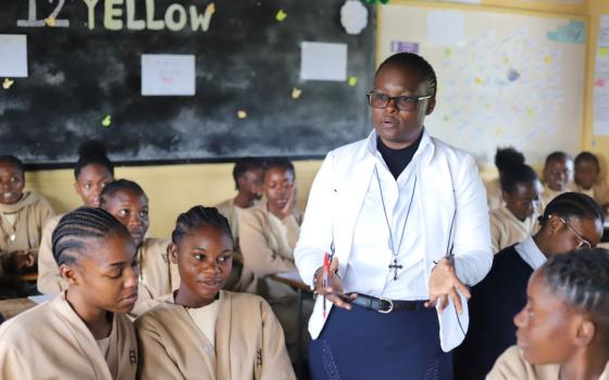 Sr. Angela Ngwenyufu, a member of the Handmaids of the Blessed Virgin Mary, interacts with her students at St. Patrick's Secondary Girls School in Lusaka, Zambia, on May 25. Through ASEC's Higher Education for Sisters in Africa program, Ngwenyufu earned a degree in education. (GSR photo/Doreen Ajiambo) 