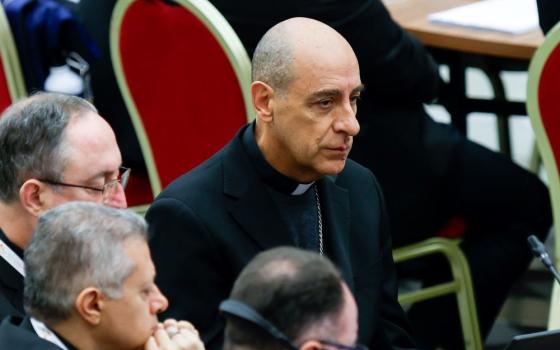 Cardinal Víctor Manuel Fernández, prefect of the Dicastery for the Doctrine of the Faith, listens to Benedictine Mother Maria Ignazia Angelini’s intervention during the morning synod session in the Paul VI Audience Hall at the Vatican Oct. 15. (CNS/Lola Gomez)