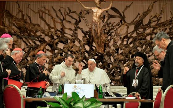 Pope Francis gives his blessing to members of the Synod of Bishops on synodality after the synod's final working session Oct. 26 in the Paul VI Audience Hall at the Vatican. The synod assembly released its final report after meeting in sessions since Oct. 2. (CNS/Vatican Media)