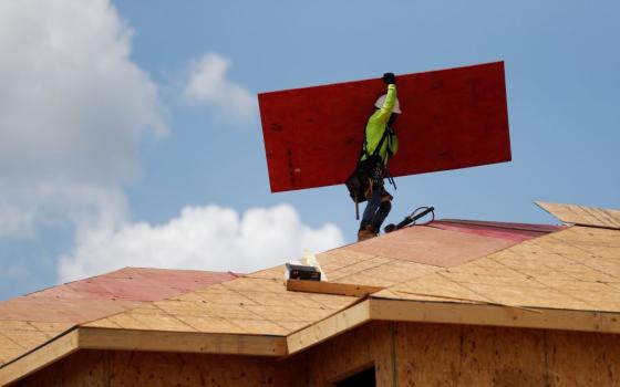 A carpenter works on building new townhomes in Tampa, Fla., May 5, 2021. In a recent NCR poll of Catholic voters in swing states, nearly half — 46% — identified affordable housing as an important issue that will influence their decisions on Election Day. CNS/Reuters/Octavio Jones)