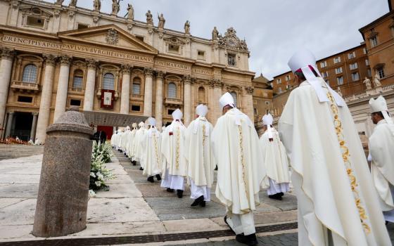 Long double-row of anonymous, vested bishops shown from behind file into looming edifice of St. Peter's. 