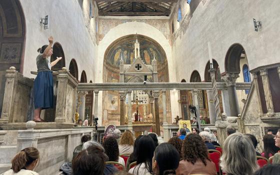 Allison Beyer of South Bend, Indiana, leads a group of pilgrims as they sing a psalm Oct. 6, 2024, at Rome's Basilica of Santa Maria in Cosmedin. Members of the Ecclesial Conference of the Amazon (known as CEAMA) and Discerning Deacons took part in a weeklong pilgrimage to share women's service to the church, to learn about deacons, and to call on the church to approve the diaconate for women as the last part of the Synod on Synodality began the first week of October at the Vatican. (NCR photo/Rhina Guidos)