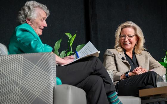 Sr. Joan Chittister and former Wyoming Republican Rep. Liz Cheney speak on the stage at the Bayfront Convention Center Oct. 17 in Erie, Pennsylvania. (NCR photo/Rick Klein)