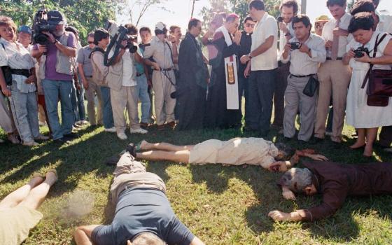 San Salvador Archbishop Arturo Rivera Damas (near center with stole) and others view the bodies of those slain at Central American University in El Salvador Nov. 16, 1989. 