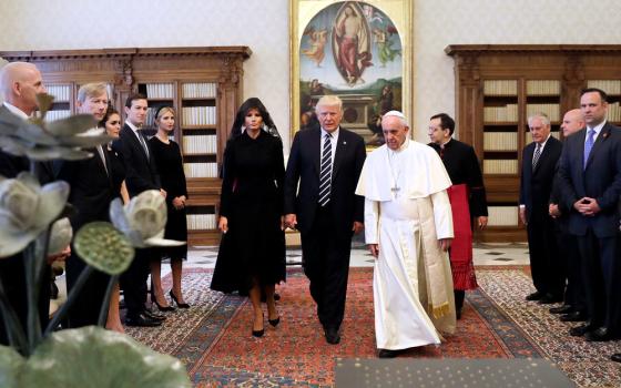 Trump walks center, to his left is Pope Francis, and to his right is Melania.