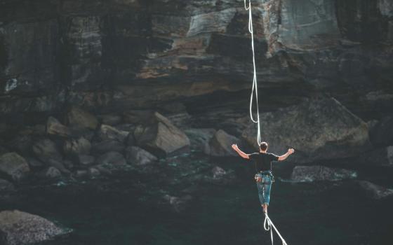 person walks a tightrope