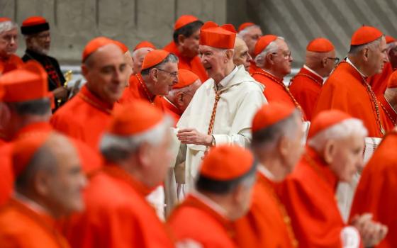 Newly created Cardinal Timothy Radcliffe, a Dominican theologian, is congratulated by other members of the College of Cardinals after receiving his red hat from Pope Francis at a consistory Dec. 7 in St. Peter's Basilica at the Vatican. (CNS/Lola Gomez)