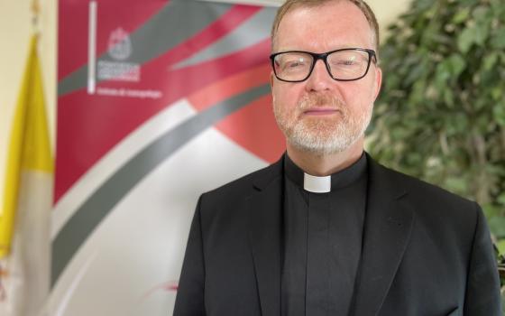 Portrait of Zollner wearing black clerics and facing camera.