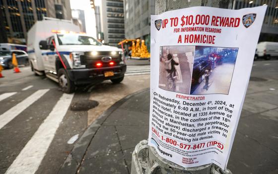 A poster is seen Dec. 5 attached to a lamppost outside the Hilton hotel near the scene where the CEO of UnitedHealthcare Brian Thompson was ambushed and shot dead the day before in New York City's midtown Manhattan neighborhood. (OSV News/Reuters/Mike Segar)