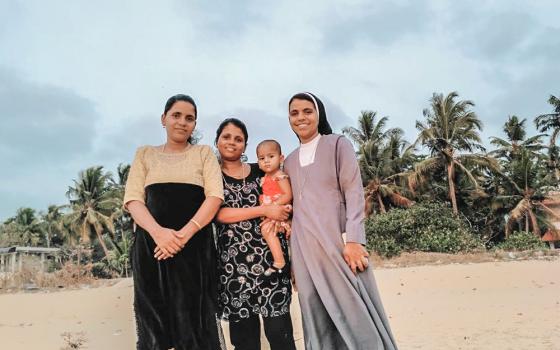 Augustinian Sr. Nidhisha Janson with her sisters at their beachside house. The siblings' parents are buried at the Church Cemetery, which is also facing eviction in Munambam, Kerala, India. (Courtesy of Nidhisha Janson)