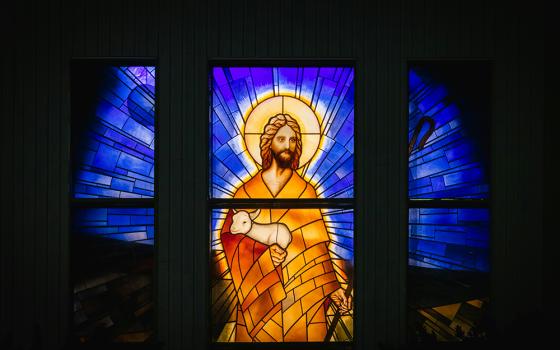 Jesus holding a lamb in stained glass (Unsplash/Greg Rosenke)