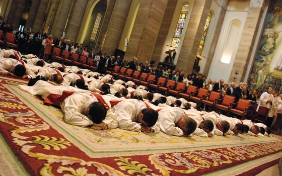 Thirty-eight men lie prostrate during their ordination as priests for Opus Dei at the Basilica of St. Eugene in Rome, in this May 26, 2007, file photo. (CNS/Courtesy of Opus Dei)