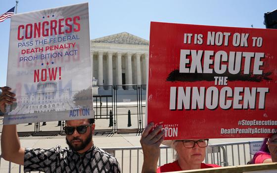 A file photo shows demonstrators holding signs protesting capital punishment in front of the U.S. Supreme Court building in Washington. (OSV News/Reuters/Kevin Lamarque)