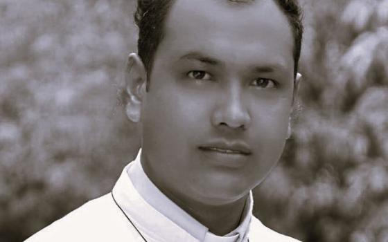 Black and white portrait of the priest.