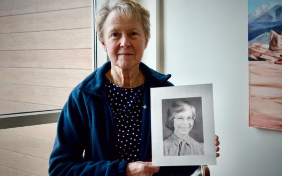 Cleveland Ursuline Sr. Gretchen Rodenfels holds a portrait of Sr. Joanne Marie Mascha, who was raped and murdered in 1995. Rodenfels taught at the same school as Mascha, and later lived with her at the motherhouse. (GSR photo/Dan Stockman)