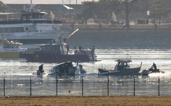 Search and rescue efforts are seen around a wreckage site in the Potomac River from Ronald Reagan Washington National Airport, Jan. 30, 2025, in Arlington, Va. (AP Photo/Mark Schiefelbein)