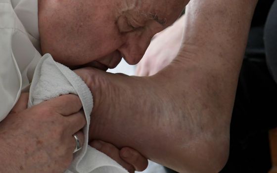 Pope Francis kisses the foot of an inmate after washing it during the Holy Thursday Mass of the Lord's Supper at a prison in Civitavecchia, Italy, April 14. (CNS/Vatican Media)