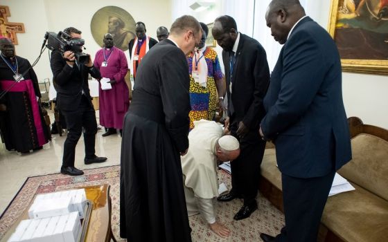 Pope Francis kneels at the feet of South Sudan President Salva Kiir at the conclusion of a two-day retreat at the Vatican for the African nation's political leaders, in this April 11, 2019, file photo. The pope plans to visit South Sudan July 5-7. 