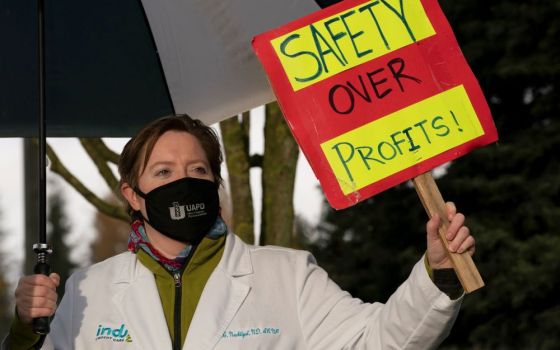 A nurse practitioner pickets outside MultiCare Indigo Urgent Care Puyallup in Puyallup, Wash., Nov. 23, 2020. (CNS/Reuters/David Ryder)