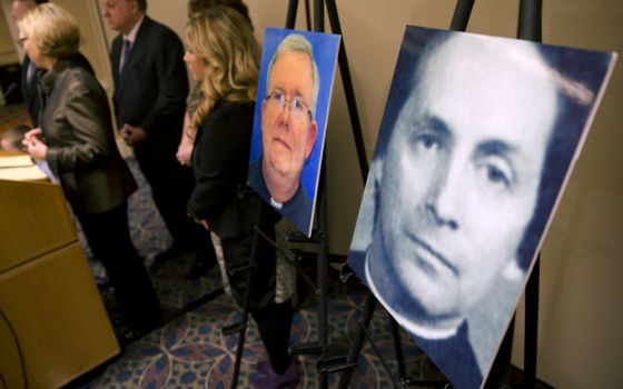 A photo of Fr. Robert Brennan, right, is displayed during a Nov. 13, 2013, news conference in Philadelphia. (AP file/Matt Rourke)