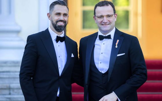 German Health Minister Jens Spahn, right, and his husband Daniel Funke, left, arrive July 5 at Bellevue presidential palace to attend a state banquet hosted by the federal president and his wife in Berlin. (AP/Christoph Soeder)