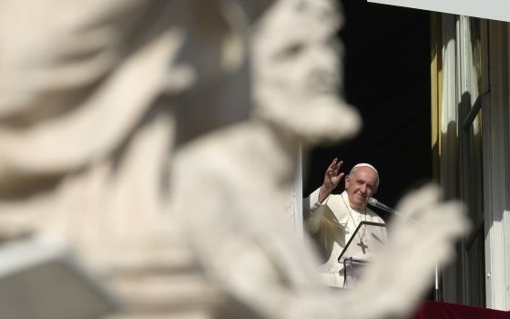 Pope Francis waves during the Angelus noon prayer from the window of his studio overlooking St. Peter's Square, at the Vatican, Sunday, Nov. 7, 2021. (AP Photo/Alessandra Tarantino)