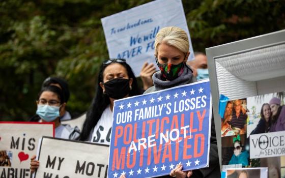 Grieving family members hold a mock funeral in the Brooklyn borough of New York City Oct. 18 to protest Gov. Andrew Cuomo's coronavirus restrictions that they say led to the deaths of their loved ones in nursing homes. (CNS/Reuters/Jeenah Moon)