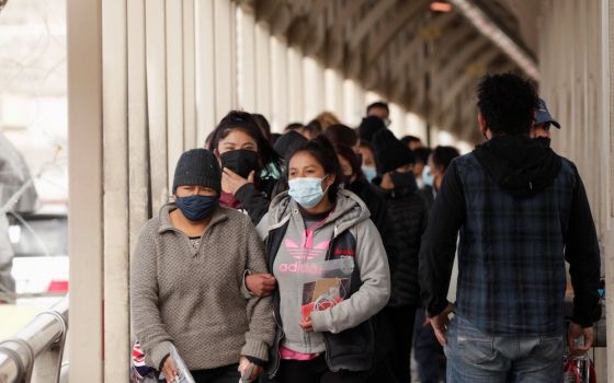 People who were deported from the U.S. walk across Paso del Norte International Border bridge in Ciudad Juarez, Mexico, Feb. 25, 2021. (CNS/Reuters/Jose Luis Gonzalez)