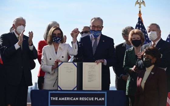 House Speaker Nancy Pelosi, D-Calif., and Senate Majority Leader Chuck Schumer, D-N.Y., display the "American Rescue Plan" March 10, 2021