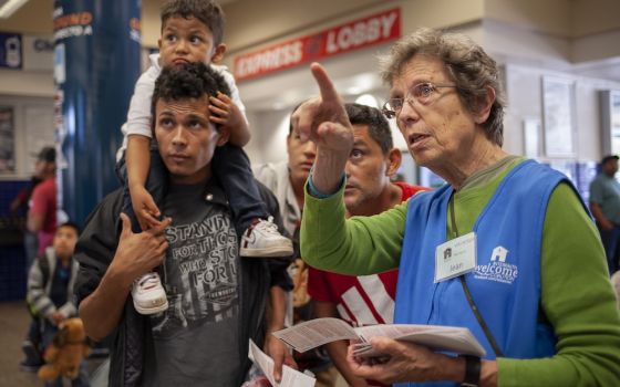 As an Interfaith Welcome Coalition volunteer, Sr. Jean Durel, a Sister of Charity of the Incarnate Word, helps Cyrilo Garcia, his son, Kelvin Naum, 3, and Juan Jose Nunez June 18, 2019, at the San Antonio Greyhound station. (GSR file photo/Nuri Vallbona)