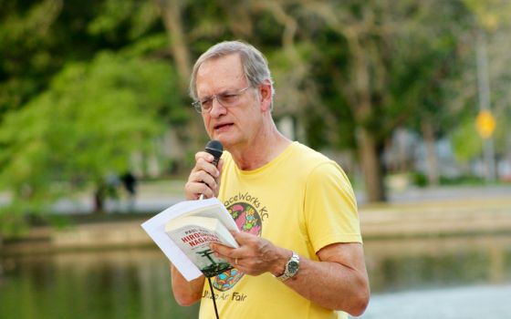 Dave Pack updates participants of the Hiroshima/Nagasaki Remembrance memorial Aug. 5 in Kansas City, Missouri, about efforts to ratify international Treaty on the Prohibition of Nuclear Weapons. (Jim Hannah)