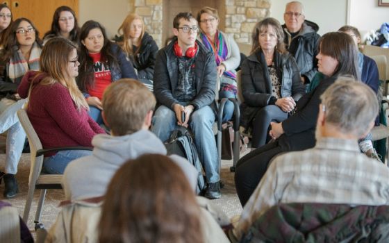 Heather Rivett, right, an actor in "The Visiting Room," sits facing an audience member during a performance March 4 at Lewis University in Romeoville, Illinois. (Joseph Glatz)