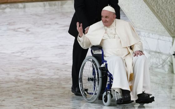 Pope Francis arrives in a wheelchair to attend an audience in the Paul VI Hall at The Vatican, May 5, 2022. (AP Photo/Alessandra Tarantino, File)