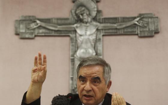 Cardinal Angelo Becciu talks to journalists during press conference in Rome, Sept. 25, 2020. (AP Photo/Gregorio Borgia)