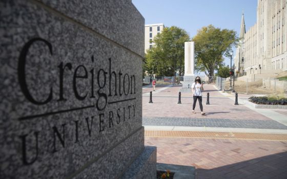 Students walk across 24th Street after the 24th Street dedication and ribbon cutting on the Creighton University campus Sept. 24, 2020, in Omaha, Nebraska.