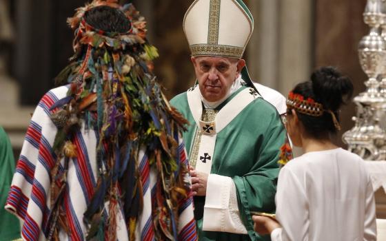 Pope Francis accepts offertory gifts from Indigenous people as he celebrates the concluding Mass of the Synod of Bishops for the Amazon at the Vatican on Oct. 27, 2019. (CNS photo/Paul Haring) 