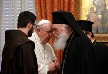 Pope Francis talks with Orthodox Archbishop Ieronymos II of Athens and all Greece during a meeting with their delegations in the Throne Room of the archbishopric in Athens, Greece, Dec. 4, 2021. (CNS photo/Paul Haring)